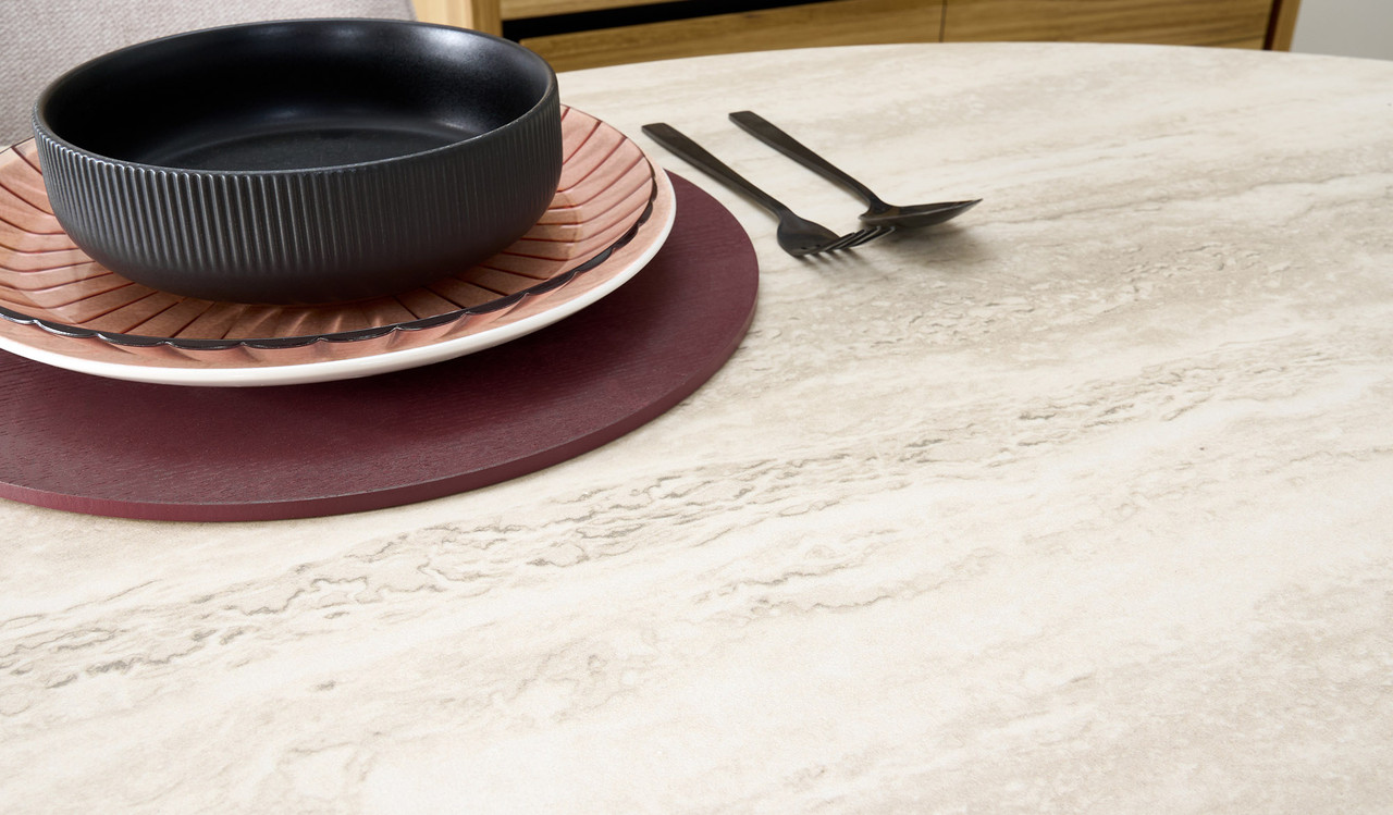 Eclipse dining table with travertine ceramic top, ash mountain grain detail, and half column slatted base in matte black or natural finish
