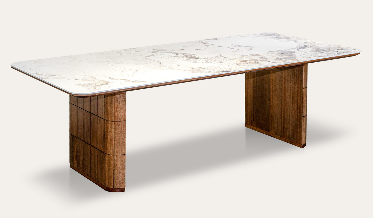 Montera dining table featuring a glossy marble-look sintered stone top with warm umber timber base, creating a bold and refined centrepiece for modern dining spaces.