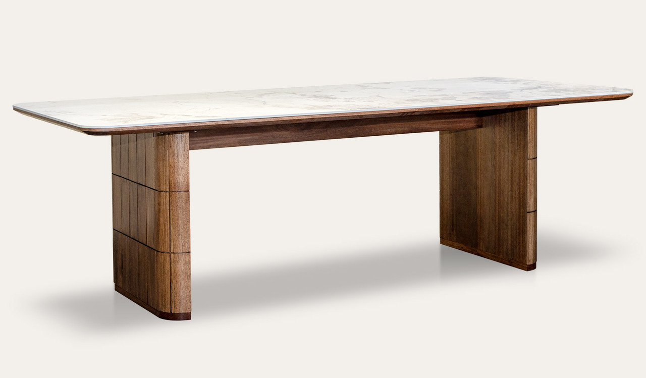 Montera dining table featuring a glossy marble-look sintered stone top with warm umber timber base, creating a bold and refined centrepiece for modern dining spaces.
