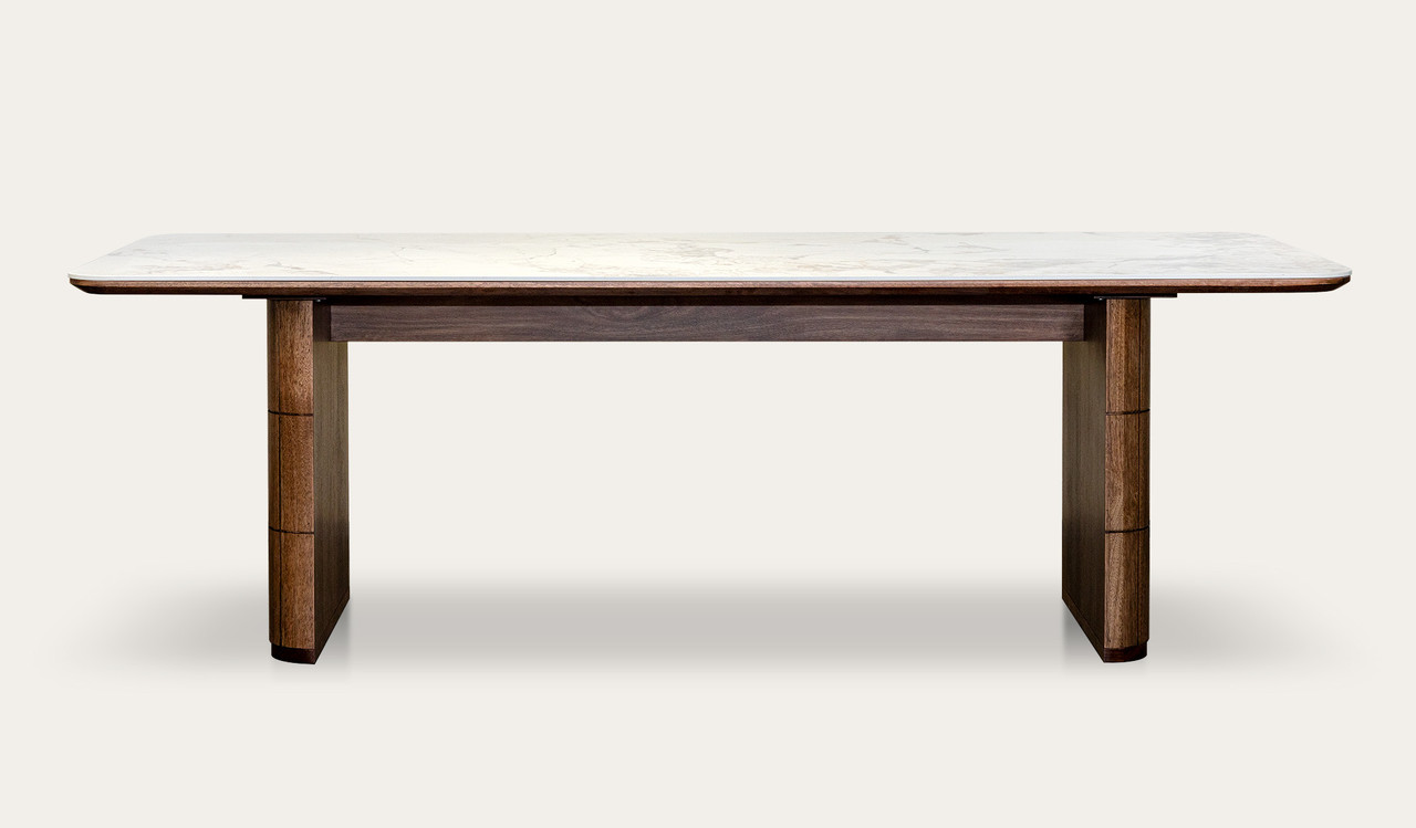 Montera dining table featuring a glossy marble-look sintered stone top with warm umber timber base, creating a bold and refined centrepiece for modern dining spaces.