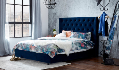 Grande bed in velvet blue with tall tufted headboard, styled in a modern bedroom setting.