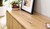 Carrera entertainment unit in Tasmanian oak timber with fluted detailing, curved silhouette, and natural water-based finish, modern timber TV cabinet