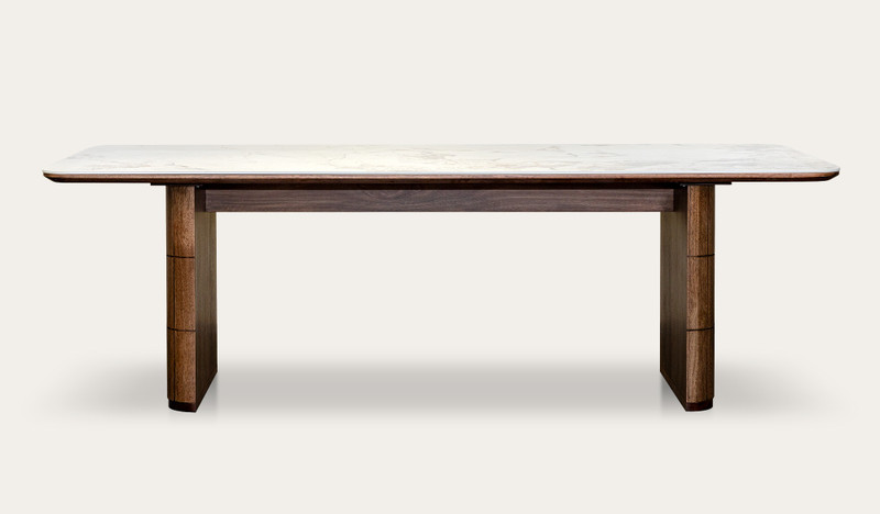 Montera dining table featuring a glossy marble-look sintered stone top with warm umber timber base, creating a bold and refined centrepiece for modern dining spaces.