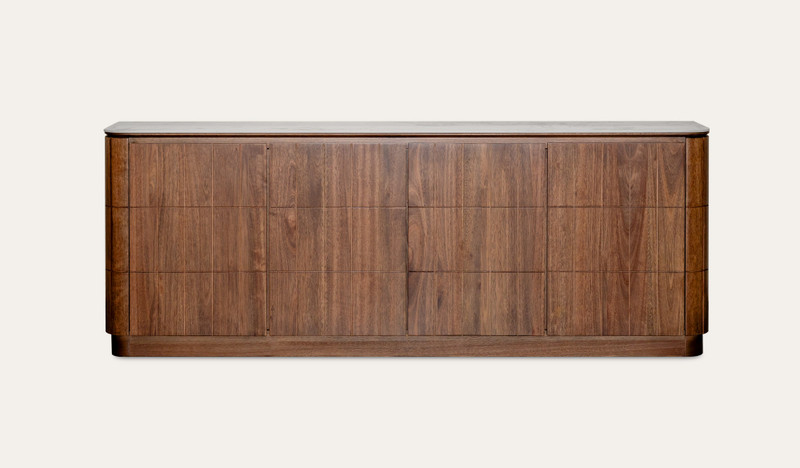 Montera buffet with a glossy marble-look sintered stone top and umber timber cabinetry, combining statement design with practical dining storage.