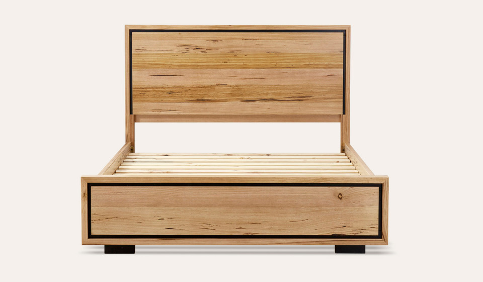 Eden bed in sustainable Australian messmate timber with natural knots, sleek edges, and black detailing, modern timber bed frame