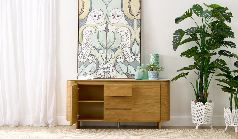 Cara buffet with matte white carrara-look ceramic top, natural oak finish, three soft-close drawers and two doors with internal shelf, 1600mm wide