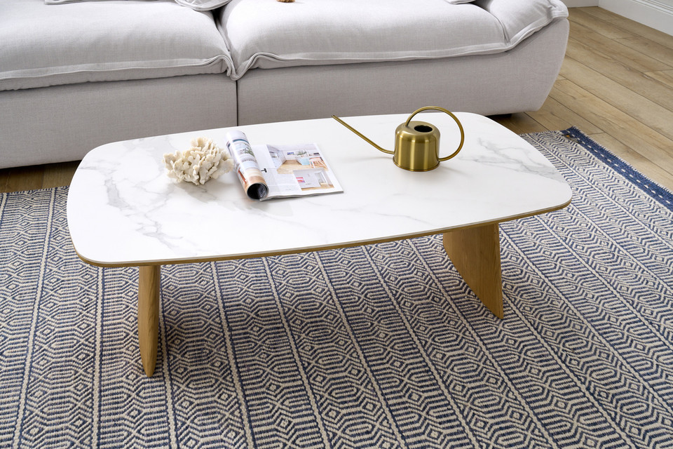 Cara coffee table with matte white carrara-look ceramic top and natural oak finish, contemporary round coffee table
