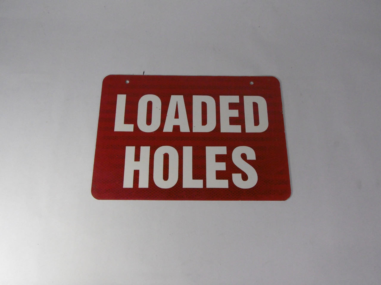 Generic Loaded Holes 14X10" Sign USED