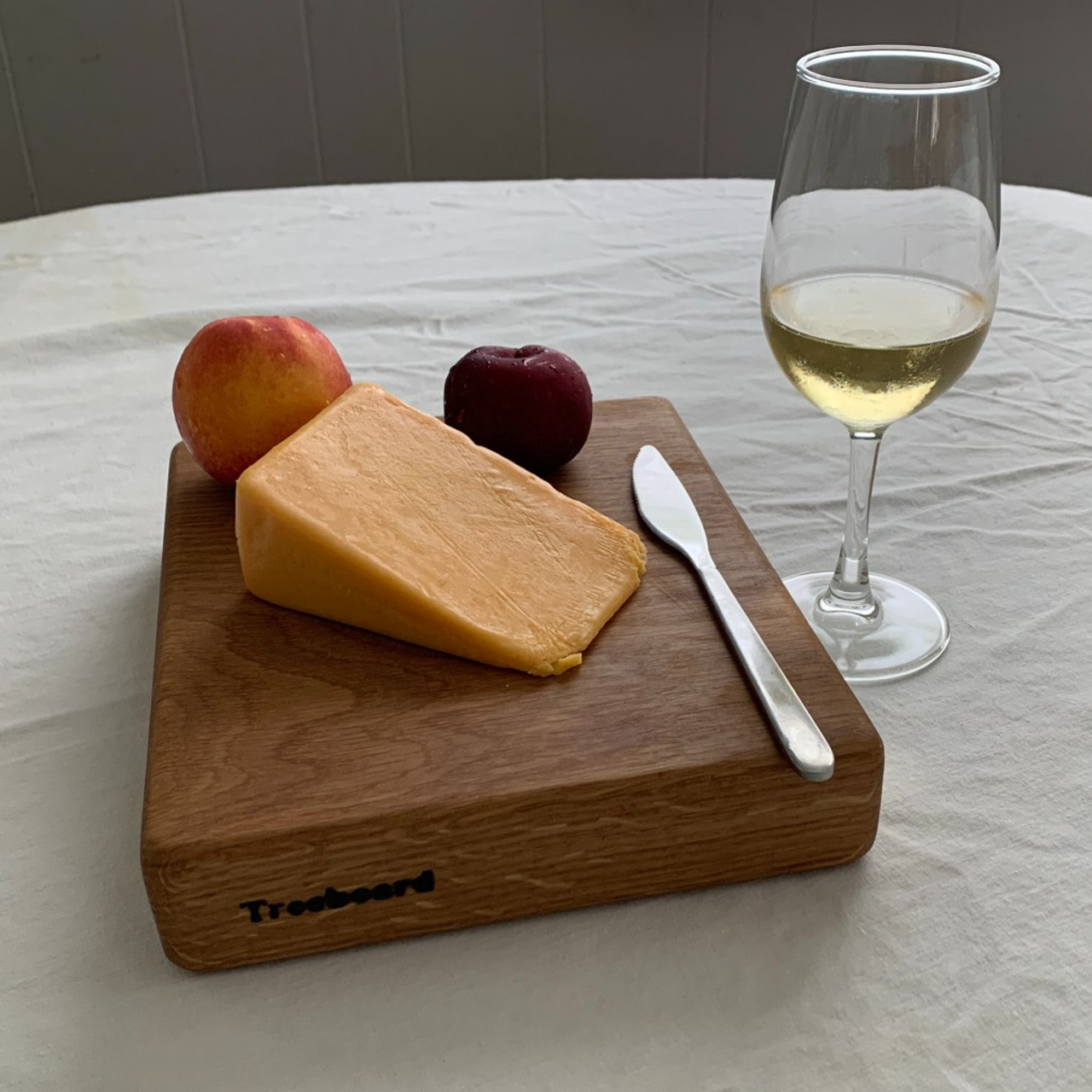 https://cdn11.bigcommerce.com/s-1vey7r6116/images/stencil/1280x1280/products/130/476/small-white-oak-cutting-board-by-Treeboard-cheddar-cheese-nectarine-plum-white-wine-glass-knife__17911.1669344772.jpg?c=1