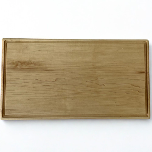 Large hard maple cutting board by Treeboard with juice groove.