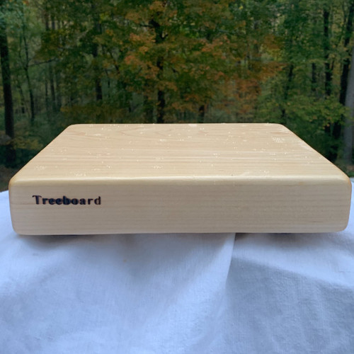 Small hard maple cutting board by Treeboard. These two-inch-thick boards are hewn from hard-rock maple for toughness and longevity and finished in linseed oil and carnauba wax.