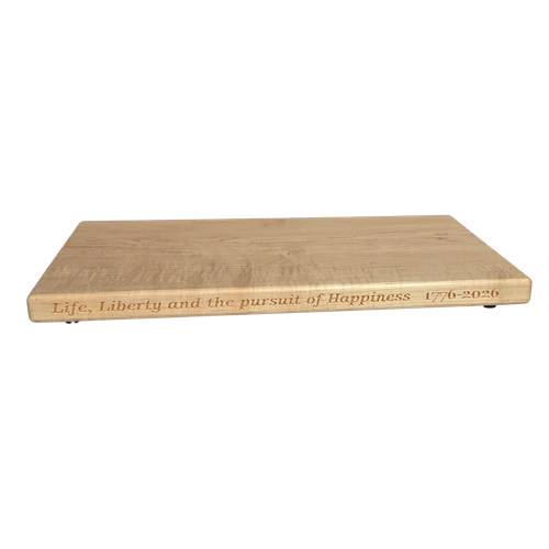 250th U.S.A. anniversary special maple cutting board by Treeboard with quotation from the Declaration of Independence: "Life, Liberty and the pursuit of Happiness." 1776-2026