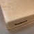 Medium hard maple cutting board by Treeboard on kraft paper with Treeboard brand created by a red-hot branding iron.