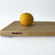 Medium hard maple cutting board by Treeboard with an orange.