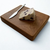 Small white oak cutting board by Treeboard with blue chesse and knife.