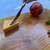 Large black cherry serving board and cutting board by Treeboard with cheddar cheese, knife and hand.