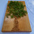 Large black cherry serving board and cutting board or cheese board by Treeboard with tree image made from parsley and almonds.