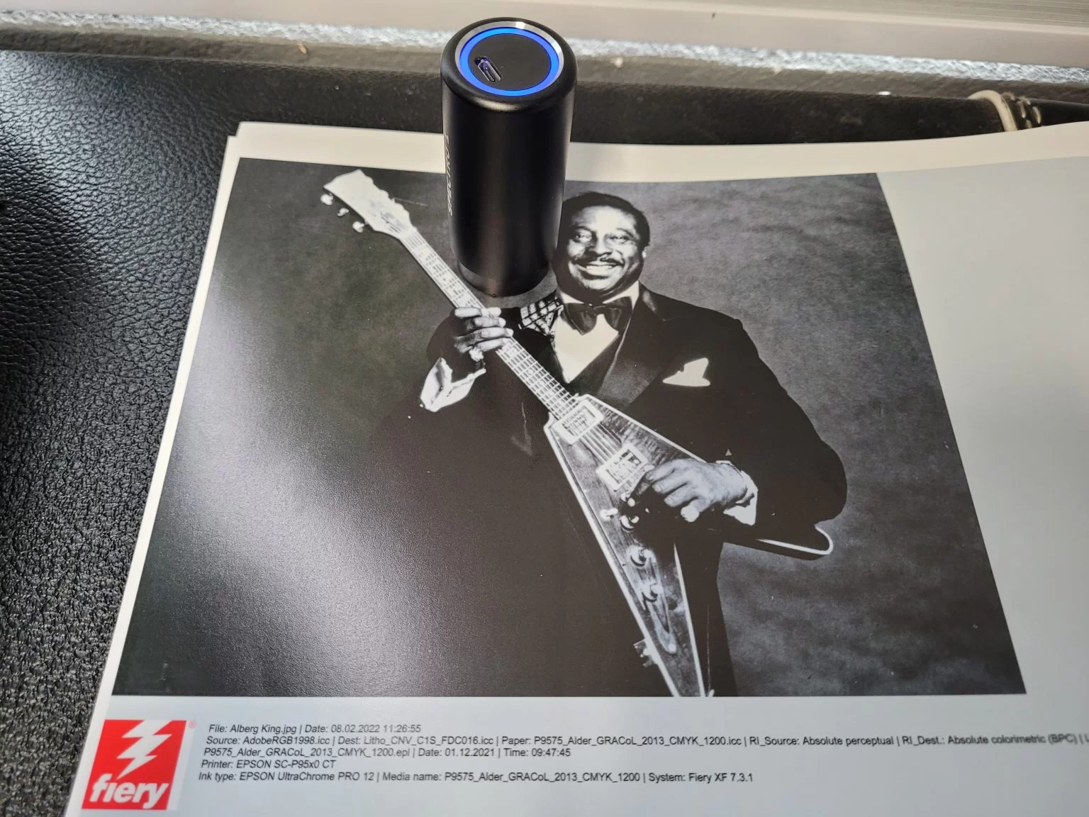 The Spectro 1 device placed on a printed proof to measure a color