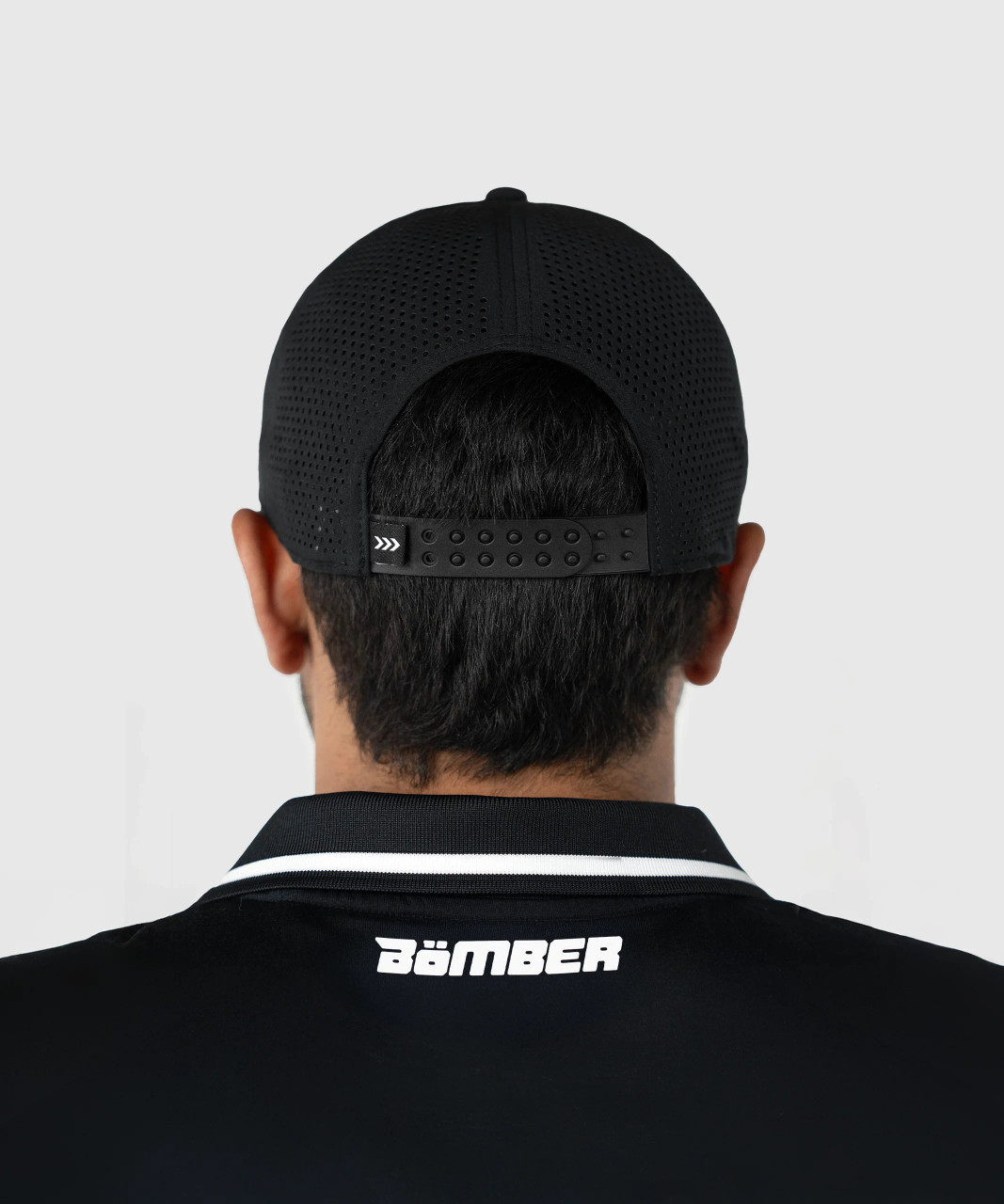 Flash Snapback, black snapback with breathable Apex mesh back panels worn by model, rear lifestyle view