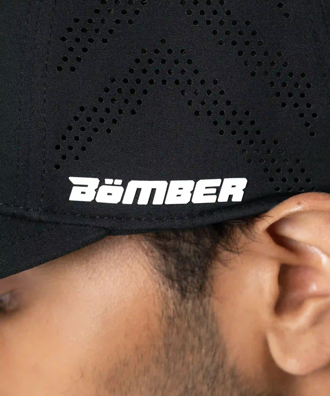 Flash Snapback, black snapback with silicone Bomber side logo, close-up view