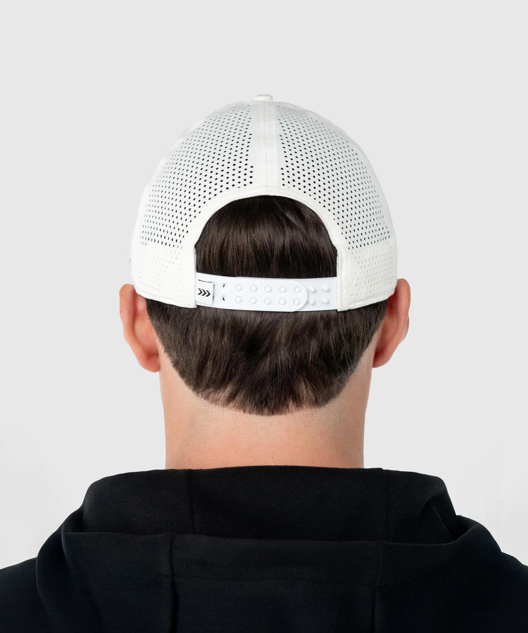 Flash Snapback, white snapback with breathable Apex mesh back panels worn by model, rear lifestyle view