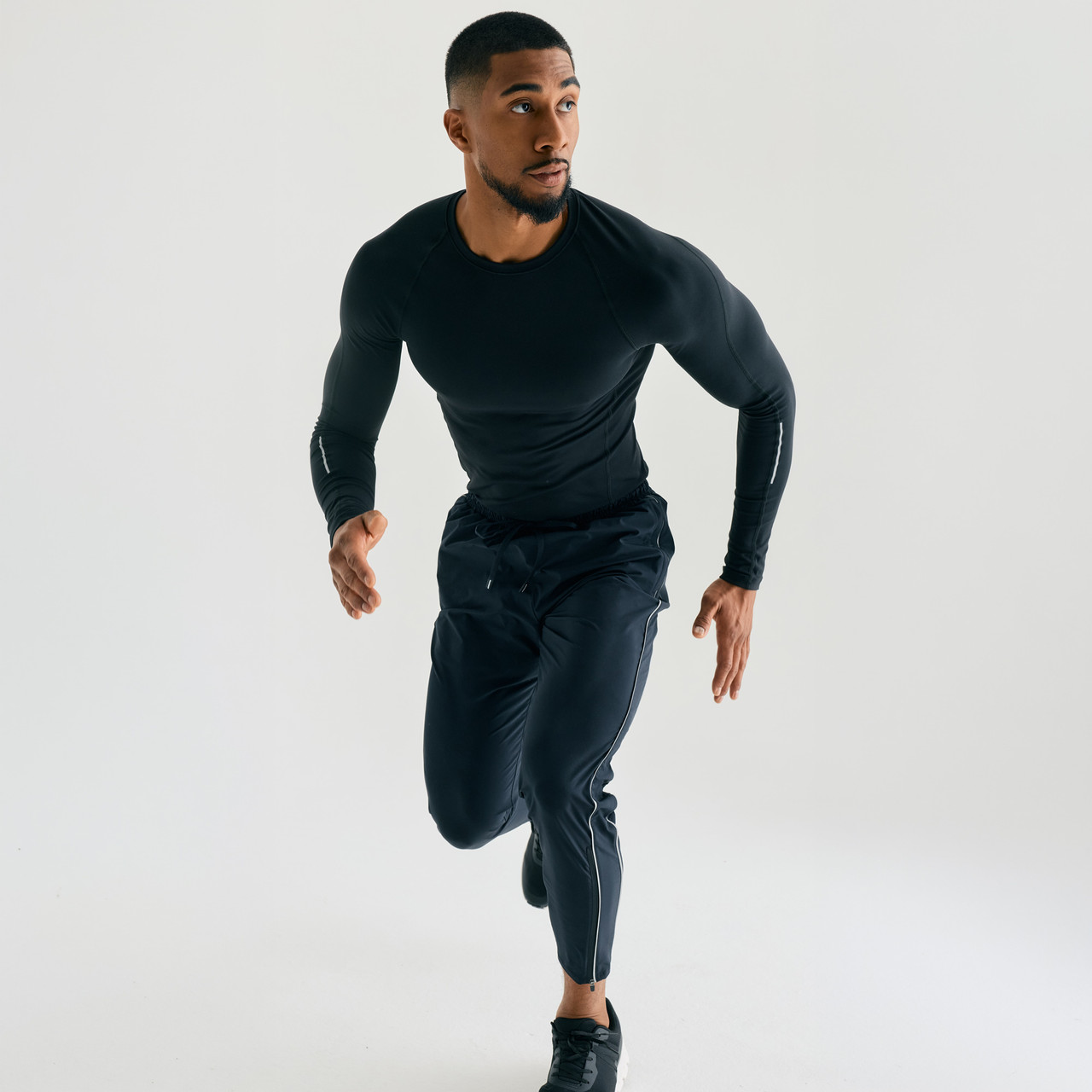 Surpass Pant, men's black jogger pants, running action shot