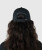 Radiance Hat, black performance hat worn by woman, back view