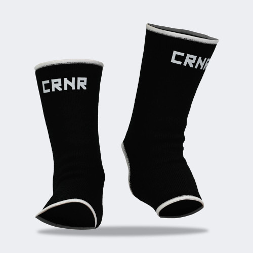 Product photo of Combat Corner’s exclusive Black HMIT Ankle Supports. This photo shows the front on foot of Combat Corner’s Black HMIT Ankle Supports. These Black HMIT Ankle Supports are part of the full HMIT (Hand Made in Thailand) product line such as HMIT Lace Up Sparring Gloves, HMIT Full Face Headgear, and HMIT Tear Drop Heavy Bags.