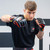 A model in a black t-shirt posing in a fighting stance while wearing the Combat Corner Red Ammy MMA Tech 6oz. Fight Glove.
