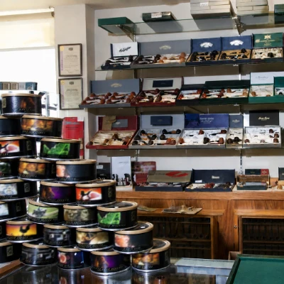 Glass jars of bulk aromatic pipe tobacco in a tobacconist shop.