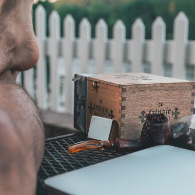 Pipe, lighter, and tin arranged as an evening smoking ritual.
