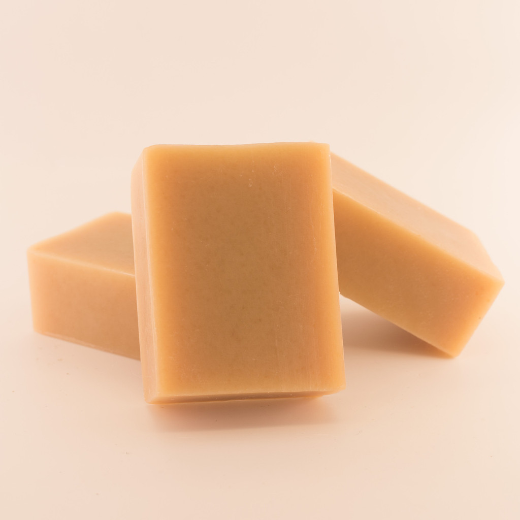 Three unwrapped bars of discounted Shea Butter goat milk soap.