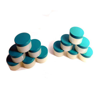 Stacked sample jars with teal caps