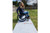 Woman in wheelchair using Access Trax Mats portable pathway over grass