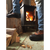 Knee-down image of model wearing Iron Age IA9650 Compound work boots inside a cabin next to a wood burning fireplace