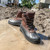 Right angle view of Iron Age IA965 Compound work boots in muddy job site water