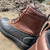 Close up left side view of Iron Age IA965 Compound work boots in muddy job site water