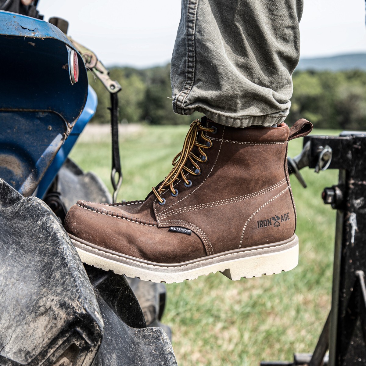 Iron Age 6 Inch Work Boots Worker stepping onto a machine in a pair of Iron Age 6 inch work boots.
