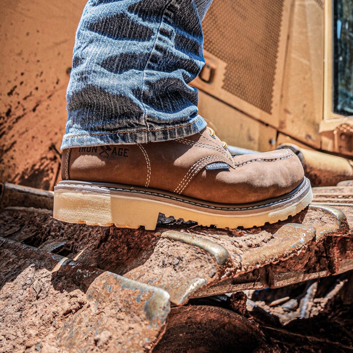 Worker climbing machinery in IA5062 defined heel work boots.