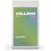 A white bag of single origin coffee with a green and indigo label. The white letters at the top of the label reads "Villino Coffee Roasters",  and the small white text at the bottom reads "Colombia El Paraiso".