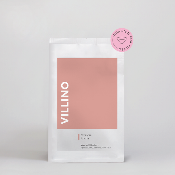 A bag of Single Origin Coffee on a white background. The earthy pink label on the bag says Villino in white letters, and reads 'Ethiopia Aricha' in small black text down the bottom.