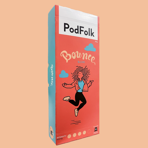 A slim box of coffee pods on a pale orange background. The red and blue box reads 'PodFolk', and features an illustration of a person with long wavy hair jumping in the air.