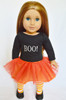 My Brittany’s Halloween outfit on an 18-inch doll featuring a black “BOO!” shirt, orange tutu, striped tights, and black shoes – fits Kennedy and Friends dolls.