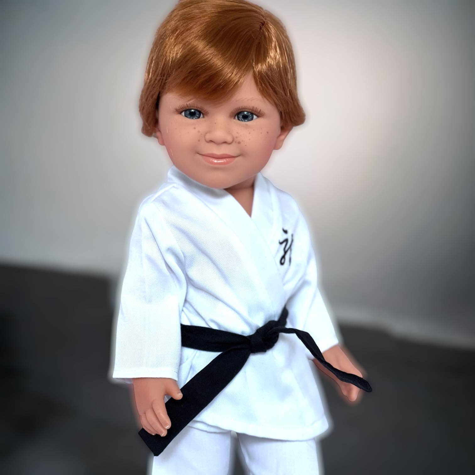 18-inch boy doll wearing white karate uniform with black belt and black shoes. Martial arts outfit by My Brittany’s® fits Kennedy and Friends dolls.