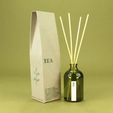 Green Botanical Tea 100ml apothecary glass reed diffuser by Heaven Scent with natural reed sticks and illustrated packaging.