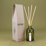 Green Botanical Herb 100ml apothecary glass reed diffuser by Heaven Scent with natural reed sticks and illustrated packaging.