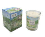 A Heaven Scent 9cl scented votive candle in a clear glass jar alongside its matching illustrated gift box. Both the candle label and the box feature. Aroma: Limeleaf & Ginger; Illustration: Cottage Garden