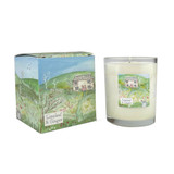 A Heaven Scent 20cl scented candle in a clear glass jar alongside its matching illustrated gift box. Aroma: Limeleaf & Ginger; Illustration: Summer Cottage