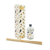 A Heaven Scent 100ml reed diffuser kit featuring a clear apothecary-style glass bottle, a bundle of 10 natural rattan reed sticks and an elegantly illustrated gift box. Aroma: Bergamot & Lemon; Illustration: British Garden Birds
