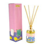 A Heaven Scent new SUMMER 100ml Reed Diffuser in a clear glass apothecary bottle with 10 natural reed sticks alongside its matching illustrated gift box. Aroma: Lemons & Green Moss; Illustration: Green Jug & Lemons